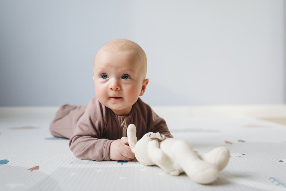 E-learning Development for Infant Classroom - Photo of Baby Lying on Bed